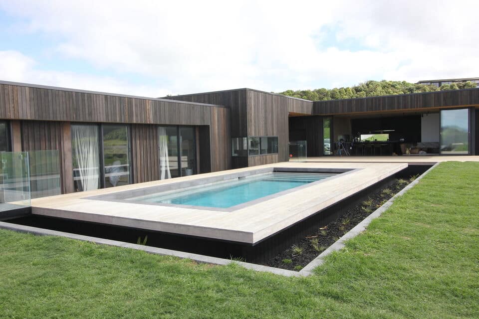 Elegant wooden outdoor gazebo with dining table and private pool deck. Stunning vineyard & ocean views for a luxury escape.