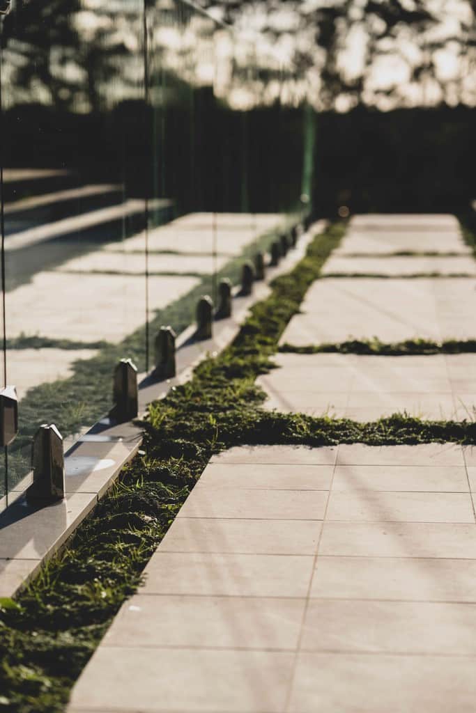 1. A grassy walkway bordered by a wooden fence, inviting visitors to stroll through the serene landscape.